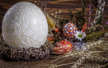 Easter decoration. colored Easter eggs and composition of dry flowers and ears