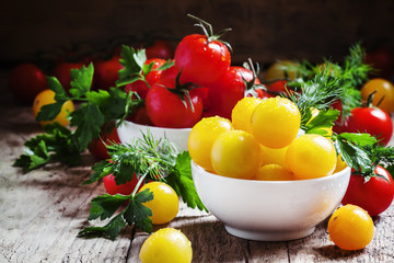 Cherry tomatoes in a porcelain bowl, vintage wooden background,