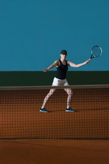 Young Girl Playing Tennis Hitting Ball