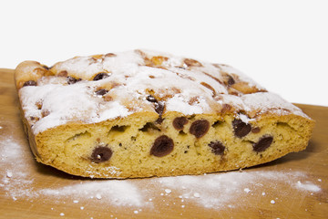 Homemade sweet Hungarian bread with prunes with sugar on a wooden surface
