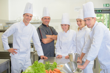 Portrait of chef with his student chefs