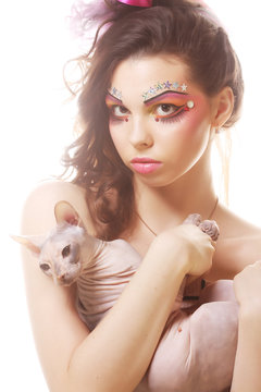 woman with creative visage holding Sphynx cat