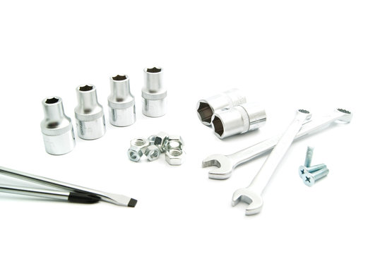 screwdrivers, wrenches and screws on white