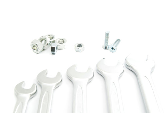 bolts and different wrenches on white