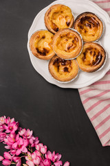 Pasteis de nata, typical Portuguese egg tart pastries on a set t