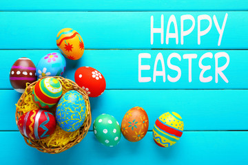 Easter greeting card. Colorful eggs on wooden background