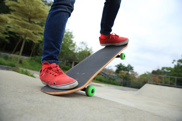 skateboarding legs at skatepark ramp