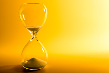 Hourglass on yellow background