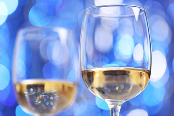 Wineglasses on blue blurred background