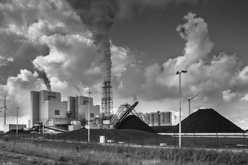 Fototapeta na wymiar Heavy industrial plant with pipes and smoke
