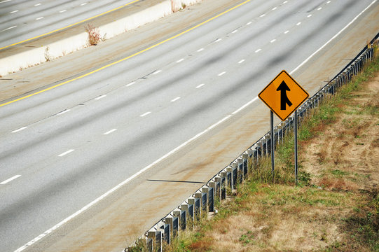 Merge Sign By The Side Of Multi-lane Highway