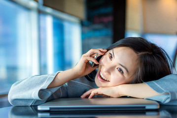 Asian woman, talking on the phone