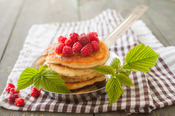 fritters in a frying pan and raspberry, selective focus