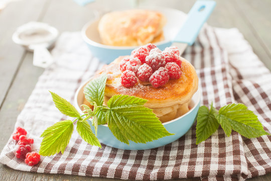 fritters in a frying pan and raspberry, selective focus