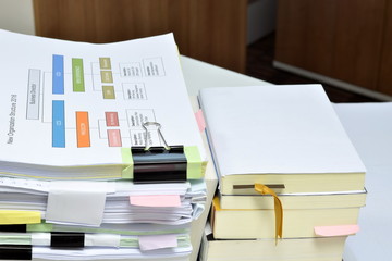 Stack of books and documents at business office