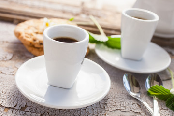 cup of coffee on a table in a garden, selective focus