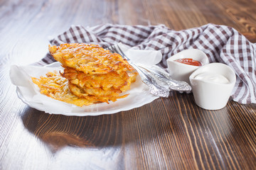 grated potatoes cutlets in a plate on a table, selective focus