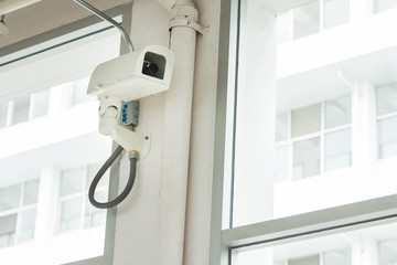 Fototapeta na wymiar Security camera in building and urban.CCTV in building