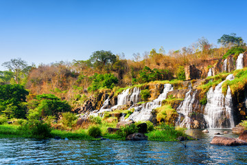 Fototapeta na wymiar Beautiful view of natural cascading waterfall and pool in autumn
