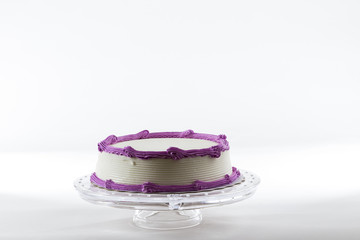 Cake with plain frosting and space for text on a bright background