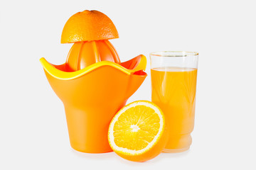 orange juice in a glass and the juice extractor, selective focus