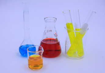 Different laboratory glassware with color liquid and chemical st