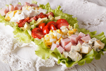 Tasty Cobb salad close-up on the table. horizontal
