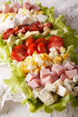 Sliced Cobb Salad close-up on a plate. Vertical
