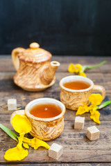spring tea in cups on a table, selective focus