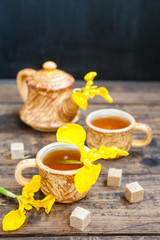 spring tea in cups on a table, selective focus
