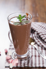 hot chocolate with a souffle in a glass on a table, selective focus