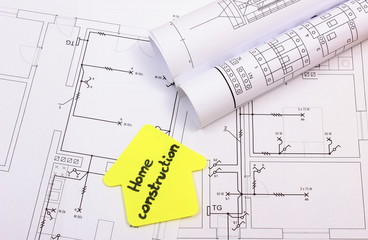 House of yellow paper with text home construction on diagram of house