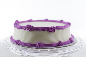 Cake with plain frosting and space for text on a bright background