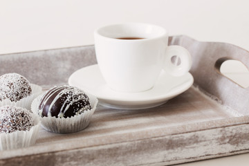 Sweet chocolate cake with cup on wooden tray