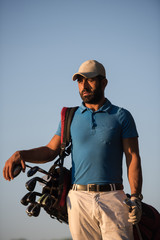 Fototapeta na wymiar golfer portrait at golf course on sunset