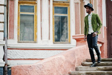Fototapeta na wymiar Fashion portrait of black african american man on green velvet j
