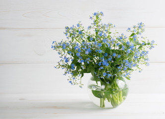 Forget-me-not flowers in glass vase