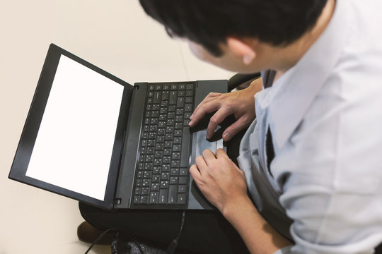 Adult man sit and typing laptop on your leg in home office