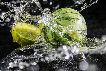 Fototapeta na wymiar watermelon with lime and water splash
