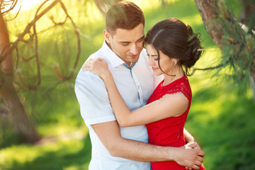 Fototapeta premium Happy young couple embrace in park
