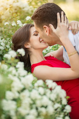 Happy young couple kissing in park