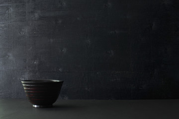 Japanese wooden bowl on the table and black color wooden background