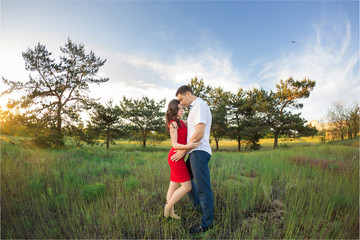 Happy young couple embrace in park