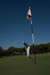 Obraz premium golf player hitting shot at sunny day