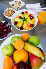 Obraz na płótnie Canvas Healthy breakfast on table: fruits and orange