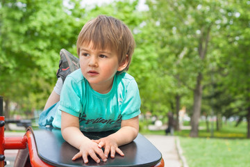 Outdoor activity - small child on outdoor fitness equipment.