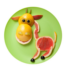 Happy giraffe made of fruits on green plate