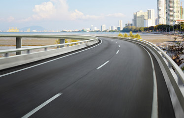 Highway overpass motion blur with city background .