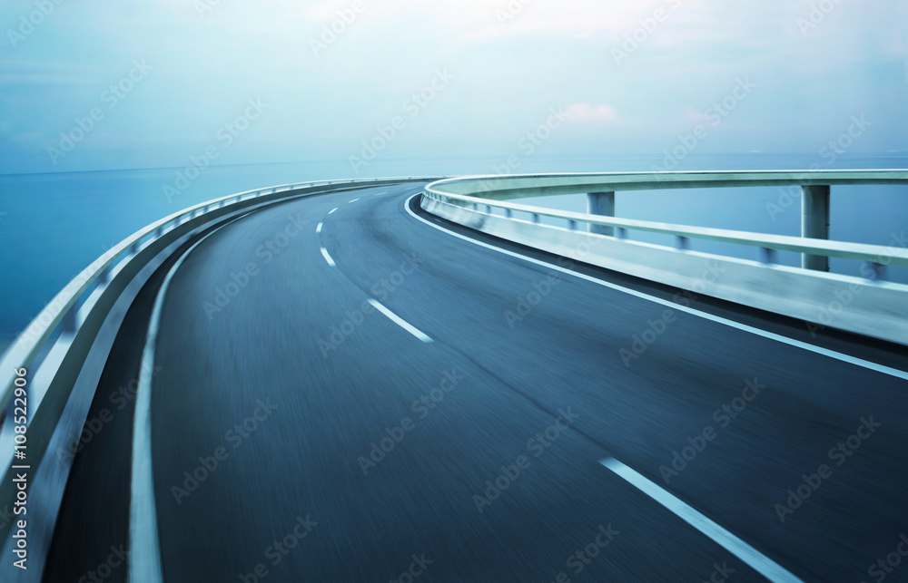 Wall mural highway overpass motion blur with coast skyline background .