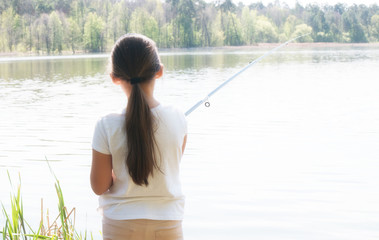 Girl fishing on the river